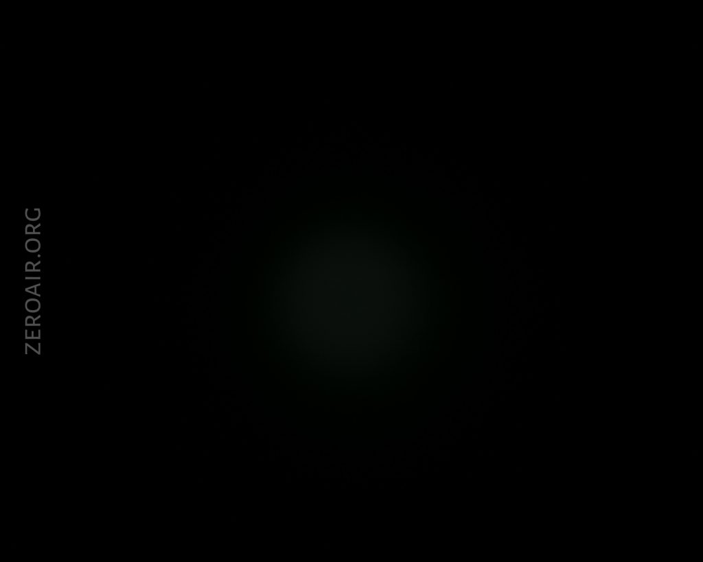 A mostly black image with a faint, small circular glow in the center. Along the left side, the text ZEROAIR.ORG is vertically visible.