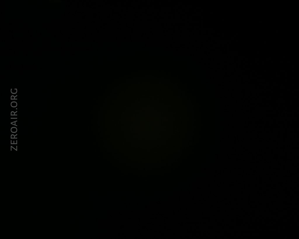 A nearly black image with faint illumination in the center. The text ZEROAIR.ORG is vertically visible along the left side of the image.