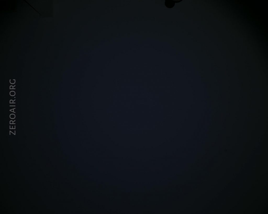 A mostly dark image with faint shadows in the corners. The text ZEROAIR.ORG appears vertically on the left side. Details in the center are not visible due to low lighting.