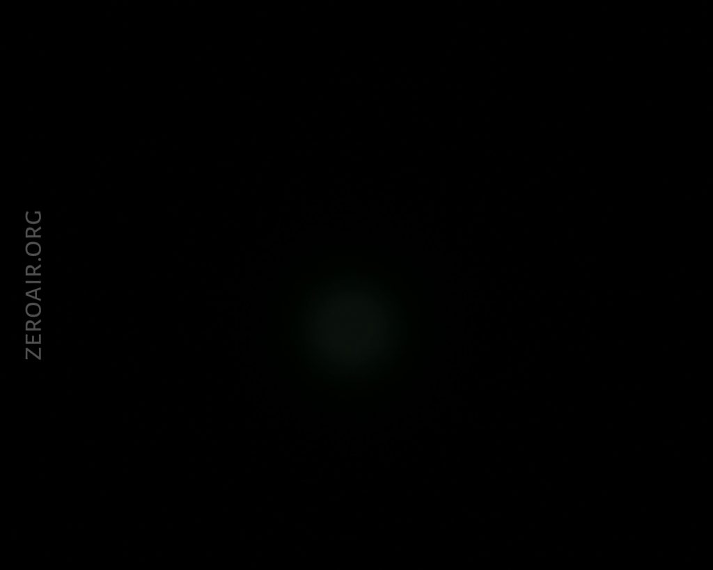 A mostly black image with a faint circular light at the center. The text ZEROAIR.ORG appears vertically along the left side of the image.