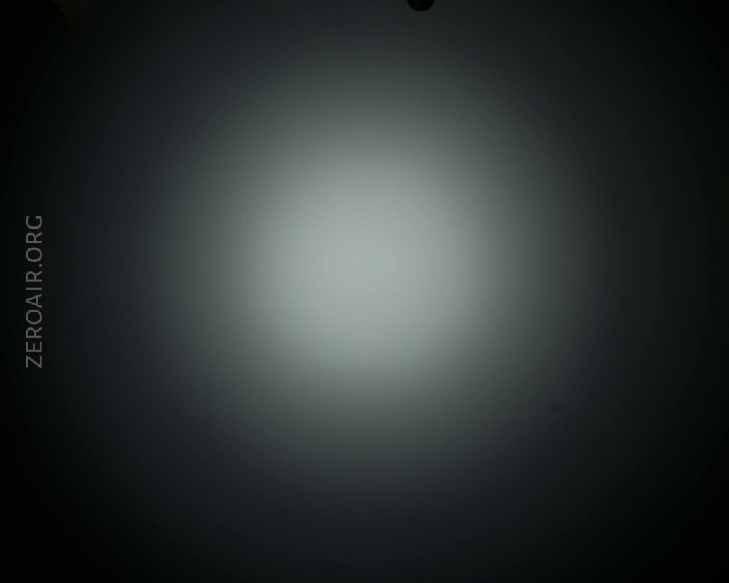 A circular white spotlight is centered on a dark background. The text ZEROAIR.ORG is vertically aligned on the left side of the image.