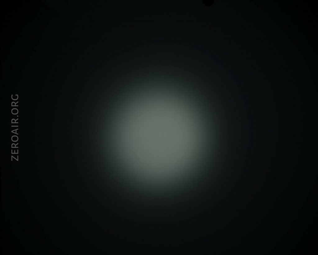A dim, circular white light shines in the center of a dark background. The text ZEROAIR.ORG appears vertically along the left side of the image.