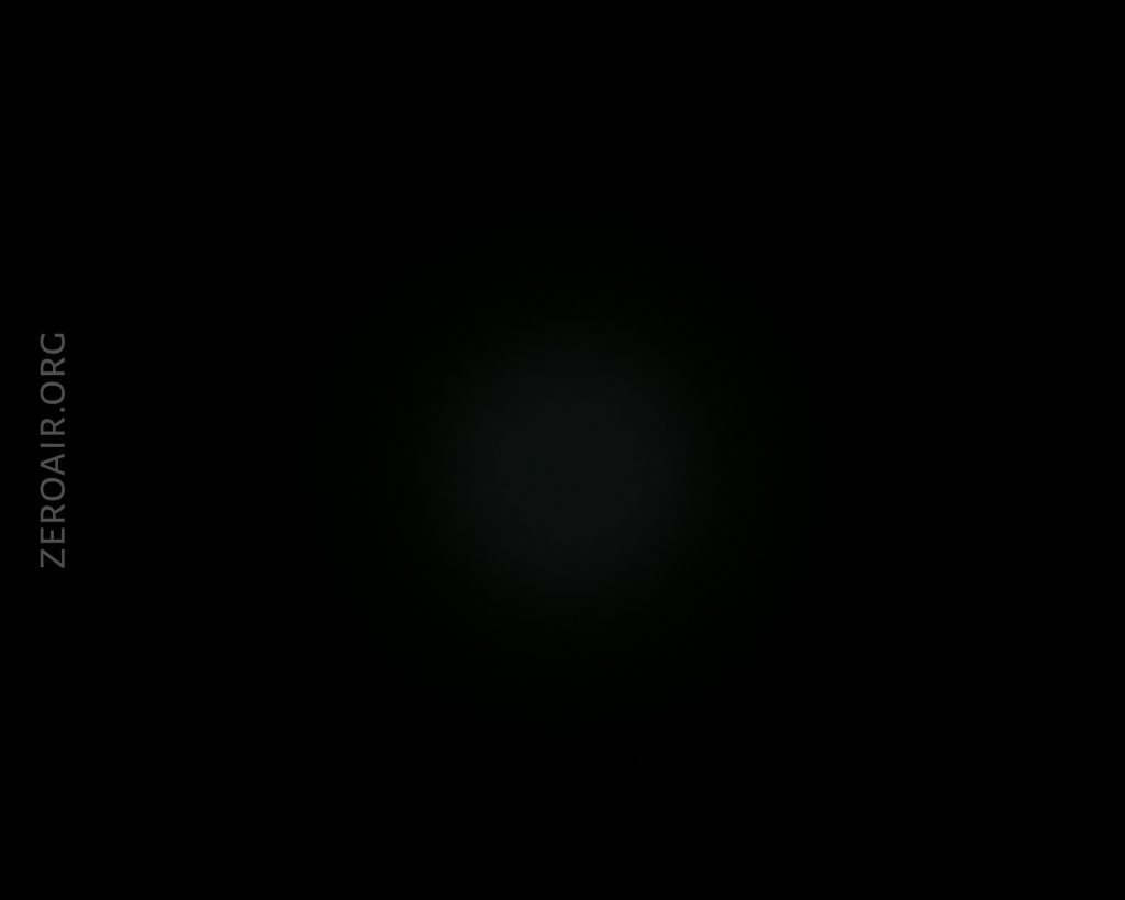 A mostly black image with a faint, dim circular spot in the center and the text “ZEROAIR.ORG” vertically aligned on the left side.
