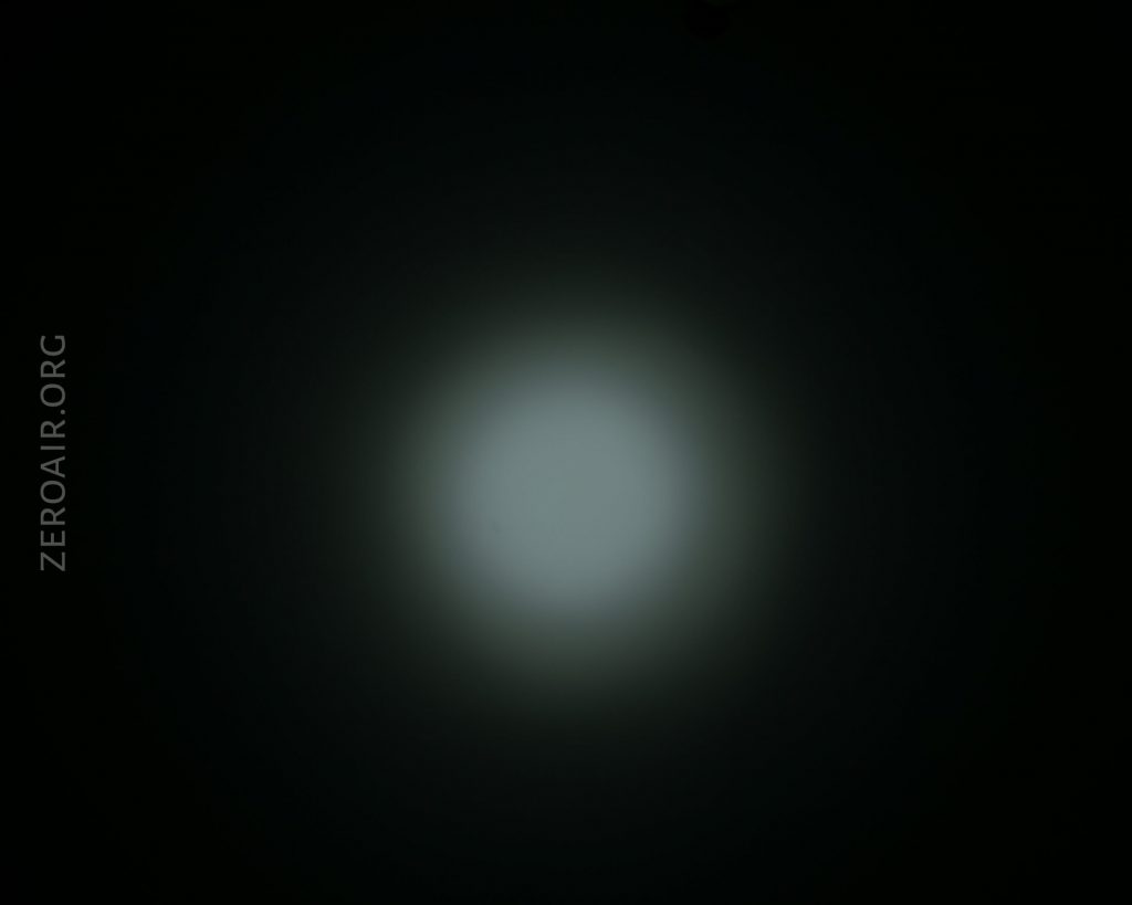 A dim, circular white light appears at the center of a dark background. The text ZEROAIR.ORG is written vertically along the left side.