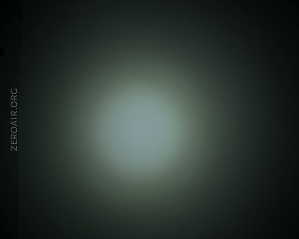 A circular, white light beam fades into darkness at the edges, creating a gradient effect. The text ZEROAIR.ORG appears vertically along the left side of the image.