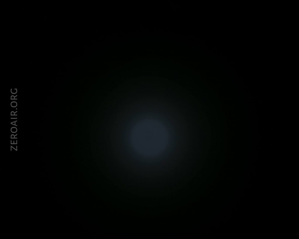 A dim, circular blue light appears in the center of a mostly black background. The text ZEROAIR.ORG is vertically aligned along the left edge.