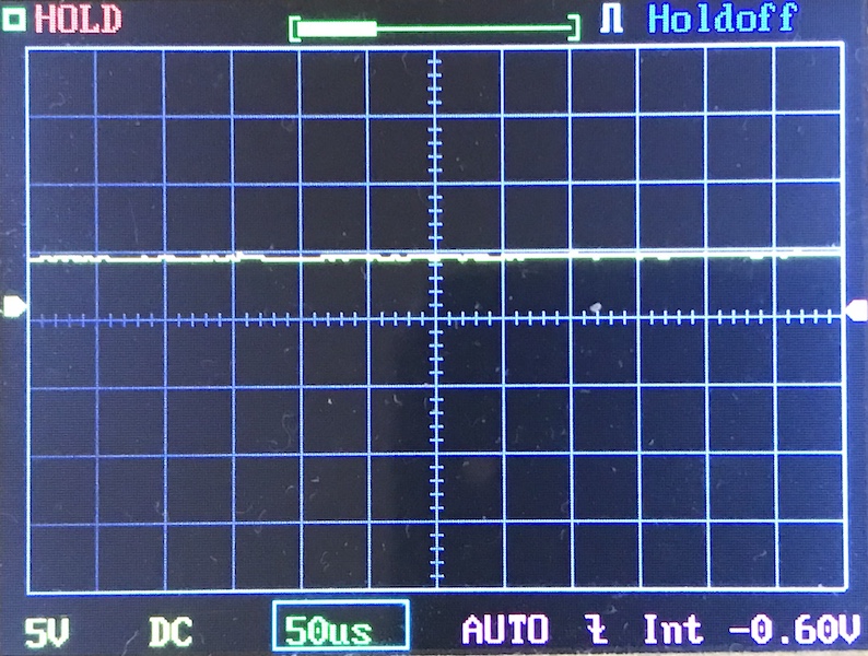 Oscilloscope screen displays a mostly flat horizontal line with minimal fluctuations, capturing the Acebeam E10 Osram's output. Settings shown include 5V, DC, 50 microseconds/division, AUTO mode, 0.60V baseline, and HOLD status at the top left.