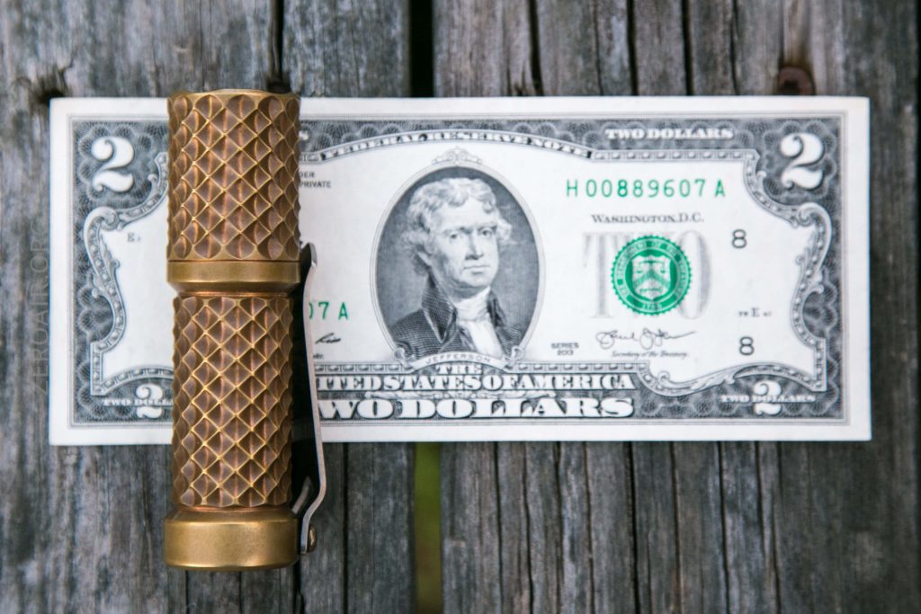 hanko trident total tesseract brass flashlight on two dollar bill