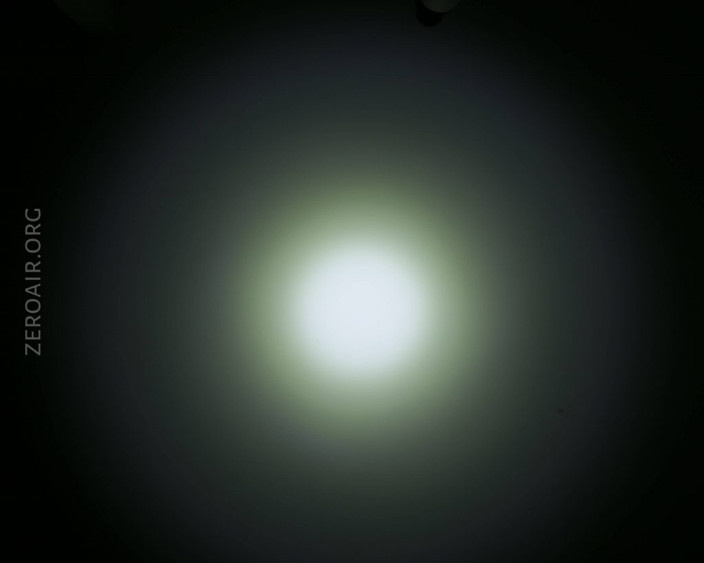 A circular white light is centered against a black background, creating a gradient halo effect. The text ZEROAIR.ORG appears vertically along the left side of the image.