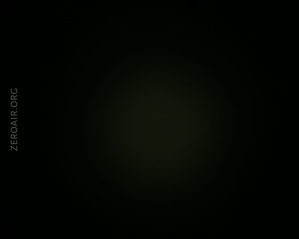 A mostly black image with a faint, barely visible circular gradient at the center. The text ZEROAIR.ORG appears vertically along the left side in light gray.