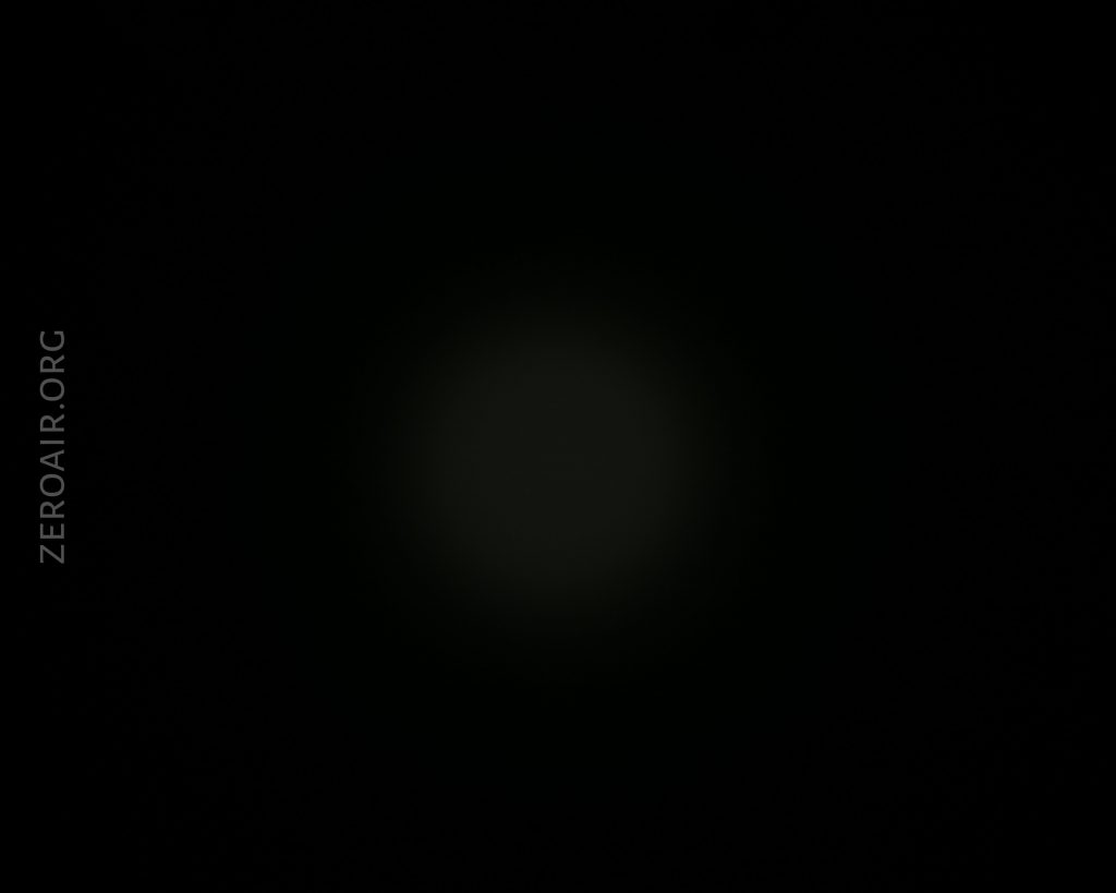 A mostly black image with a very faint, soft circular light in the center. The text ZEROAIR.ORG appears vertically on the left side.