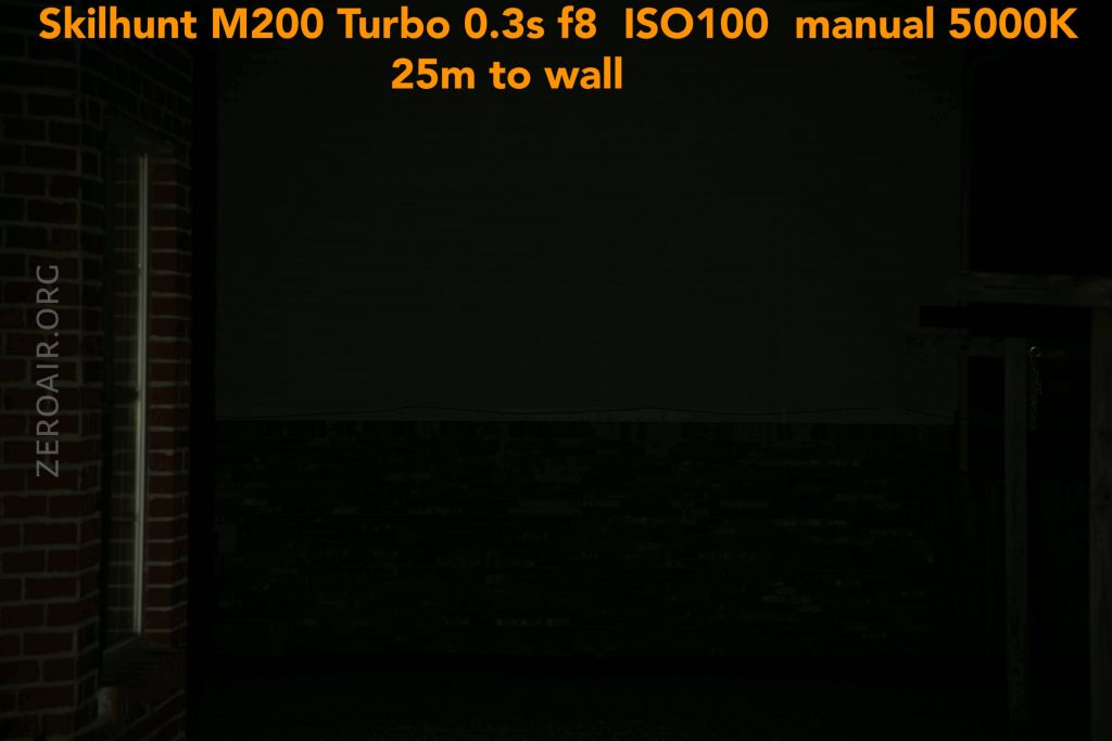 A dimly lit brick wall at night is illuminated by a Skilhunt M200 Turbo flashlight. Orange text at the top details camera and light settings: 0.3s f8, ISO100, manual 5000K, 25m to wall. “ZEROAIR.ORG” is on the left.