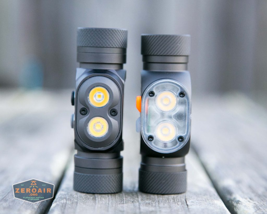 Two black, cylindrical flashlights stand upright side by side on a wood surface. Each has dual LED lights on the front. The left flashlight has exposed LEDs; the right has a translucent cover. A ZeroAir sticker is in the lower left corner.
