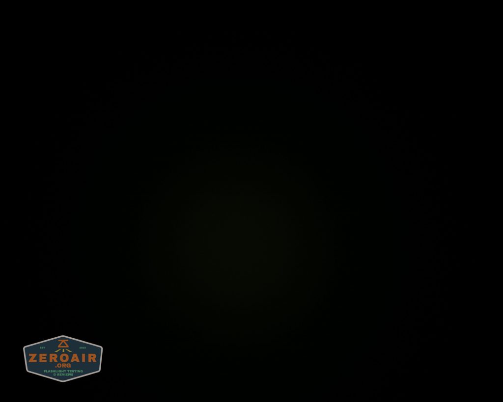 A nearly black image with a faintly visible dark center. In the lower left corner, there is a small logo with the text ZEROAIR and some smaller, unreadable text below it.