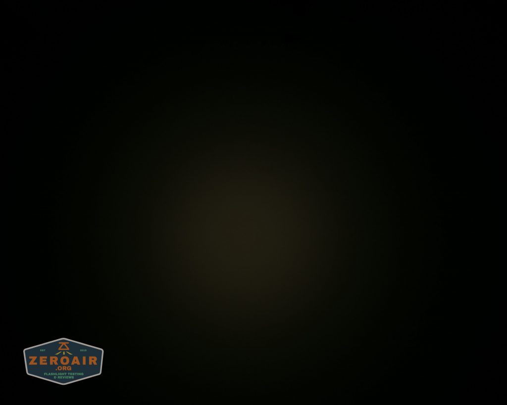 A mostly dark image with a faint circle of dim light in the center. The lower left corner has a small logo that reads ZEROAIR.