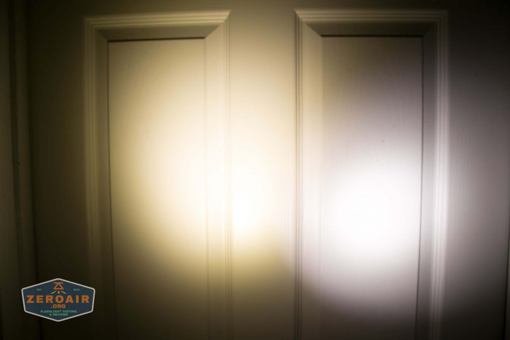 A closed white door with two panels is illuminated by two overlapping flashlight beams, one on the left and one on the right. A logo that reads ZeroAir appears in the lower left corner.