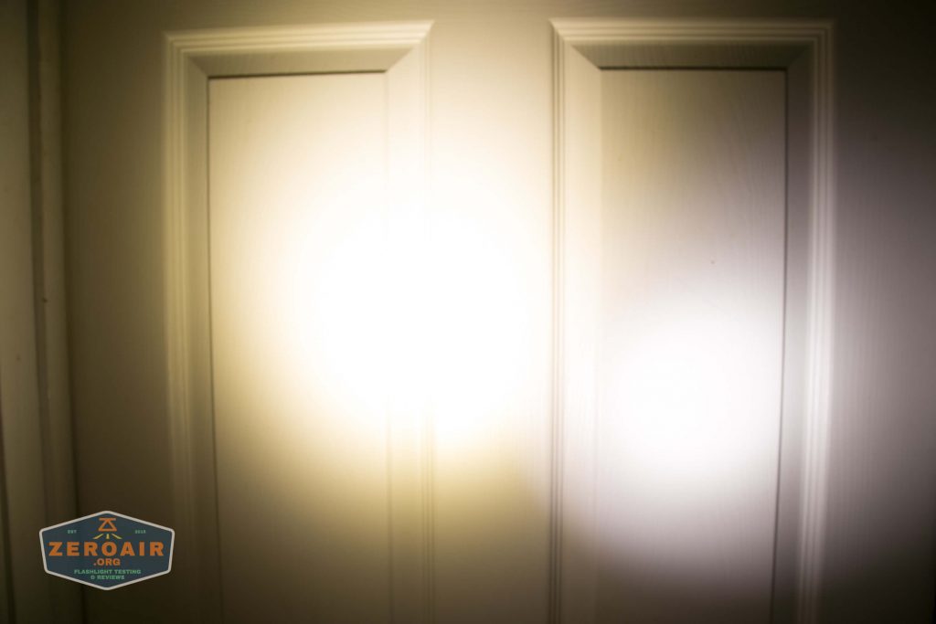 A white door with rectangular panels is illuminated by a bright flashlight beam in the center. A logo reading ZeroAir is visible in the lower left corner.