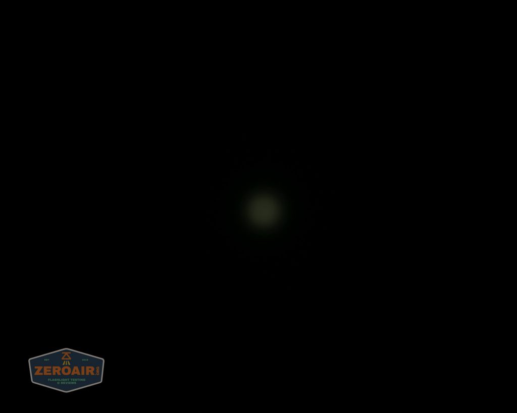 A mostly black image with a small, dim, round white light in the center. In the lower left corner, there is a shield-shaped logo with the text ZEROAIR and smaller, unreadable text below it.