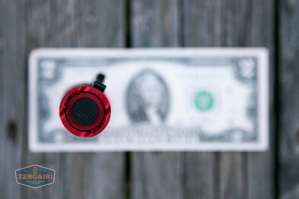thrunite tt20 the outsider red 21700 flashlight on two dollar bill
