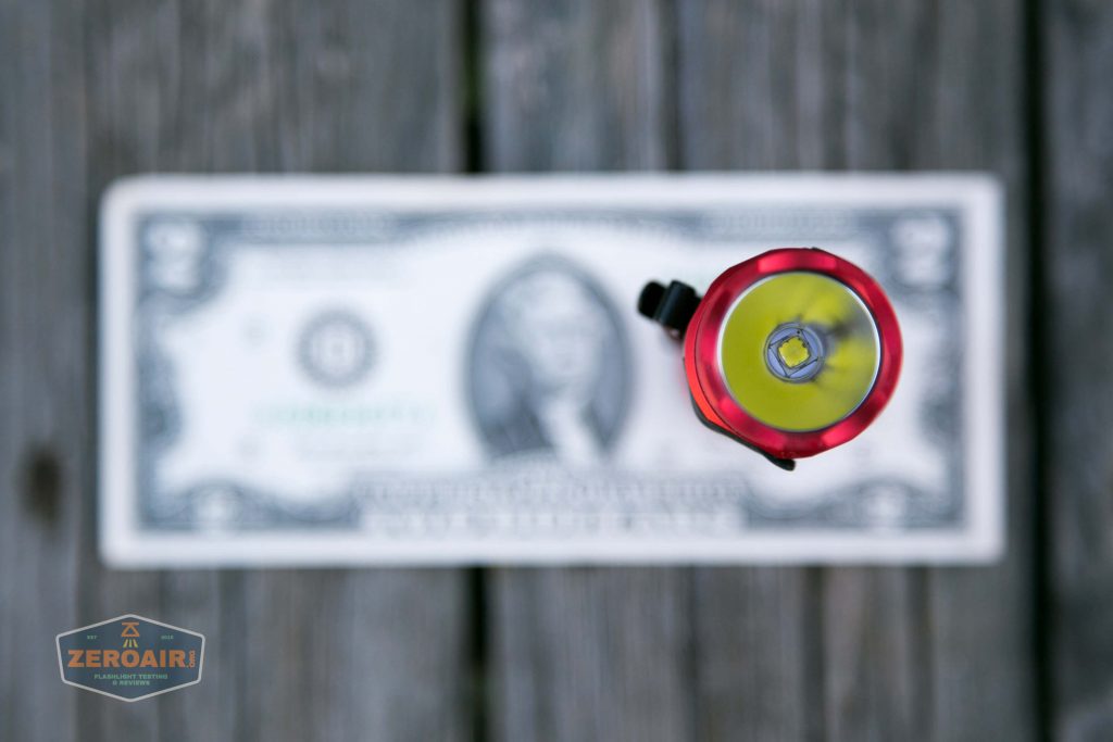 thrunite tt20 the outsider red 21700 flashlight on two dollar bill