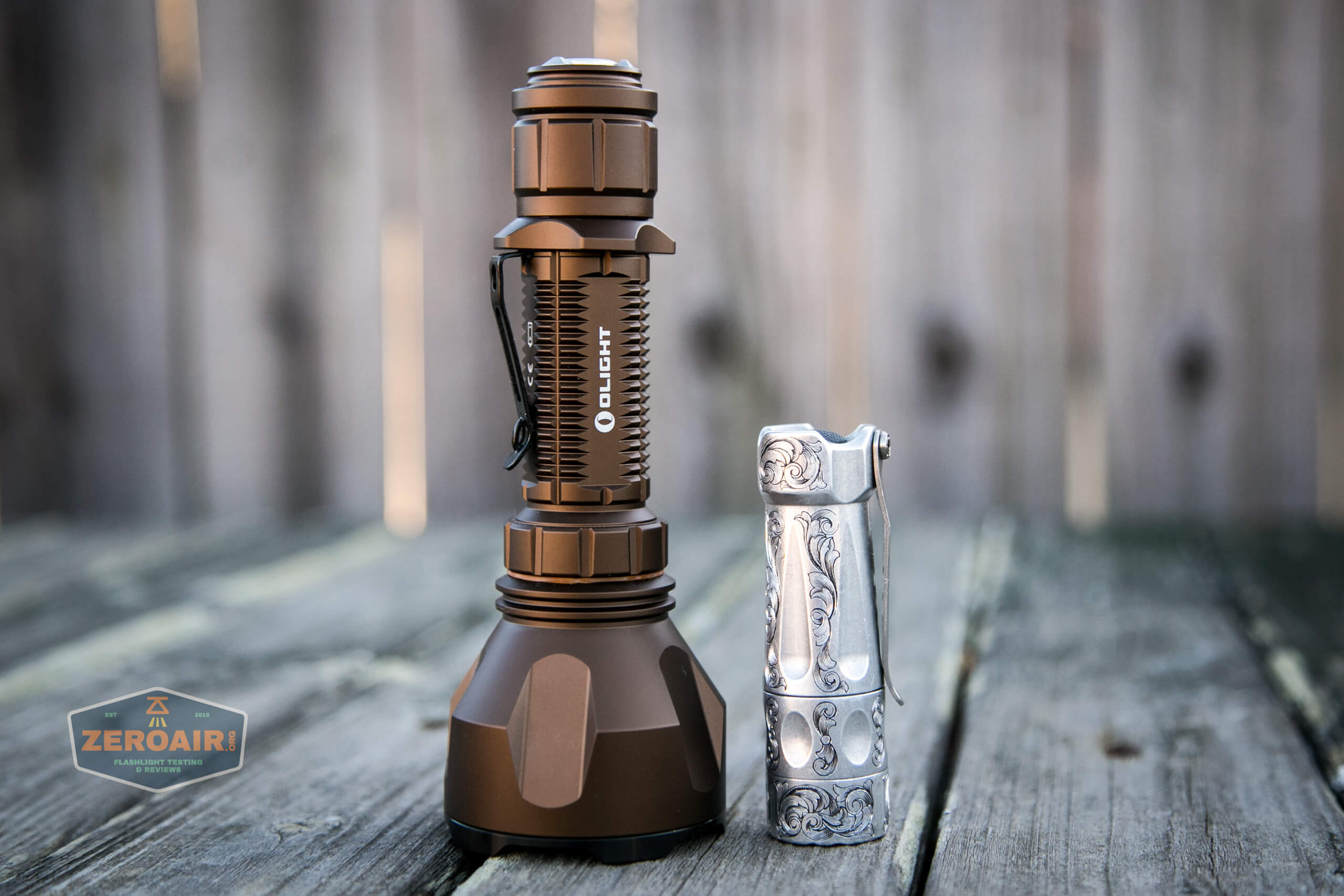 olight warrior x turbo desert tan flashlight beside torchlab boss 35
