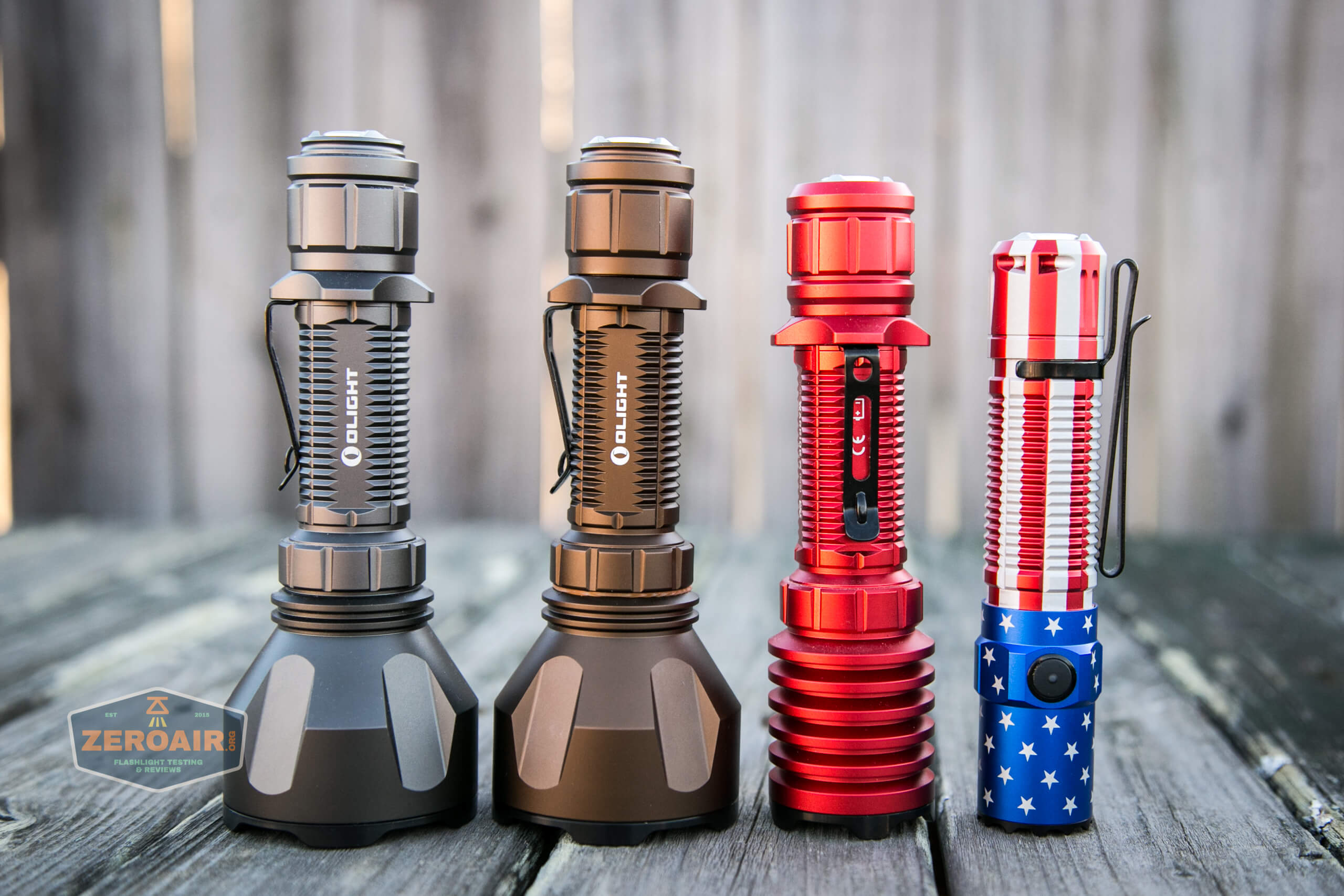 olight warrior x turbo desert tan flashlight beside other olights