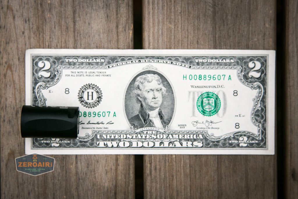 cyansky m2 keychain flashlight on two dollar bill