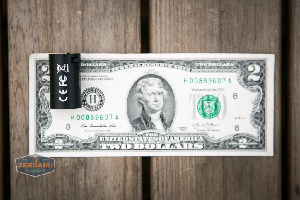 cyansky m2 keychain flashlight on two dollar bill