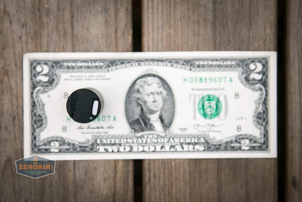 cyansky m2 keychain flashlight on two dollar bill