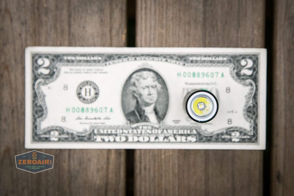cyansky m2 keychain flashlight on two dollar bill