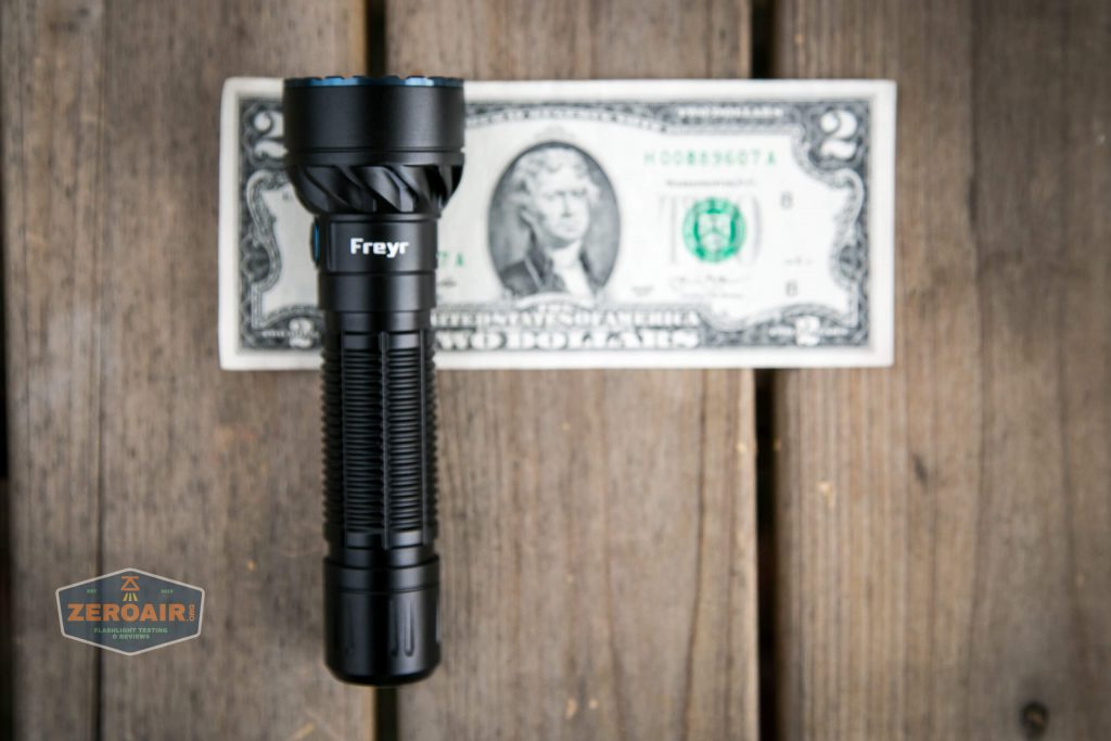olight freyr rgb flashlight on two dollar bill