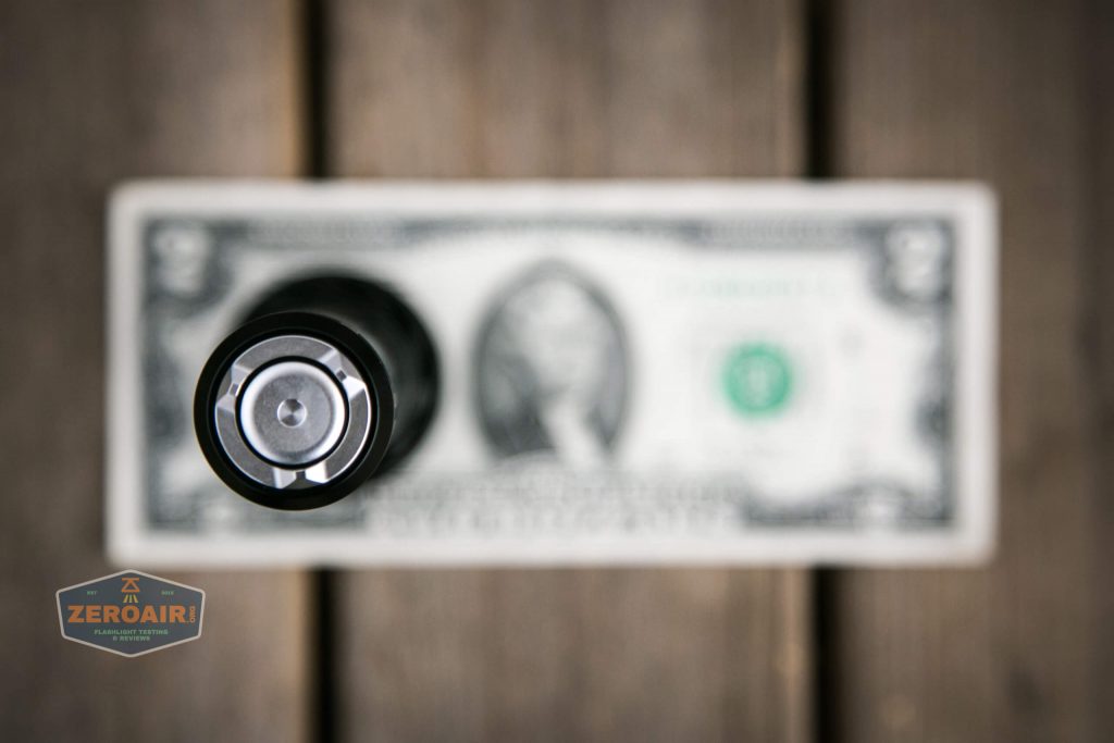 olight freyr rgb flashlight on two dollar bill