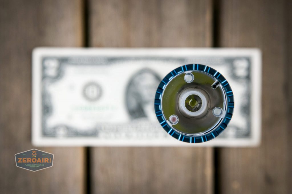 olight freyr rgb flashlight on two dollar bill