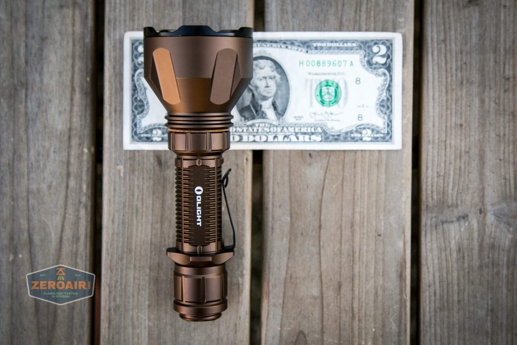 olight warrior x turbo desert tan flashlight on two dollar bill