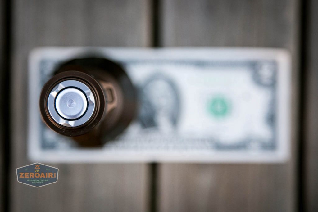 olight warrior x turbo desert tan flashlight on two dollar bill