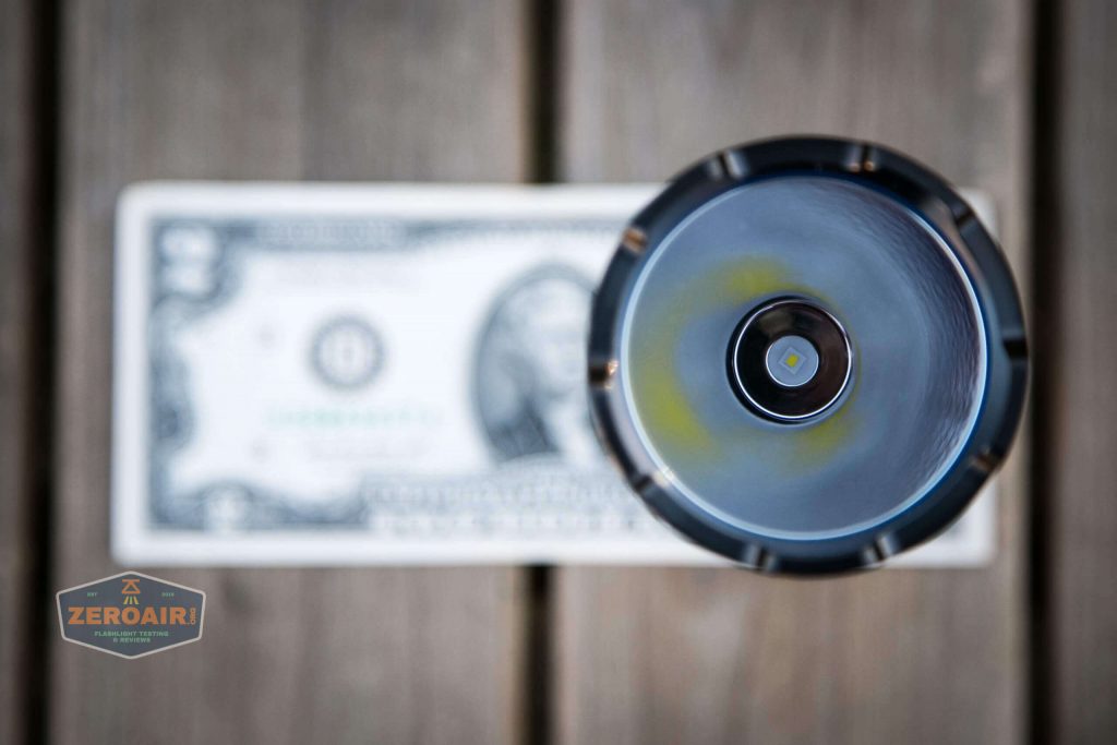 olight warrior x turbo desert tan flashlight on two dollar bill