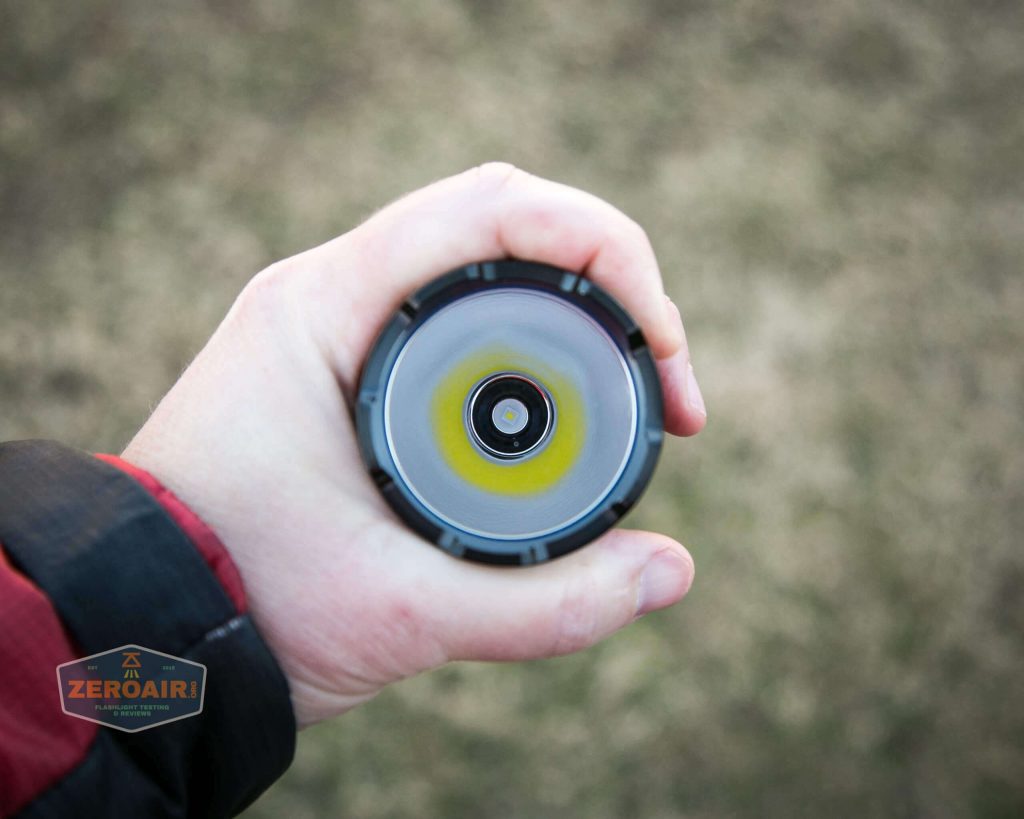 olight warrior x turbo desert tan flashlight in hand