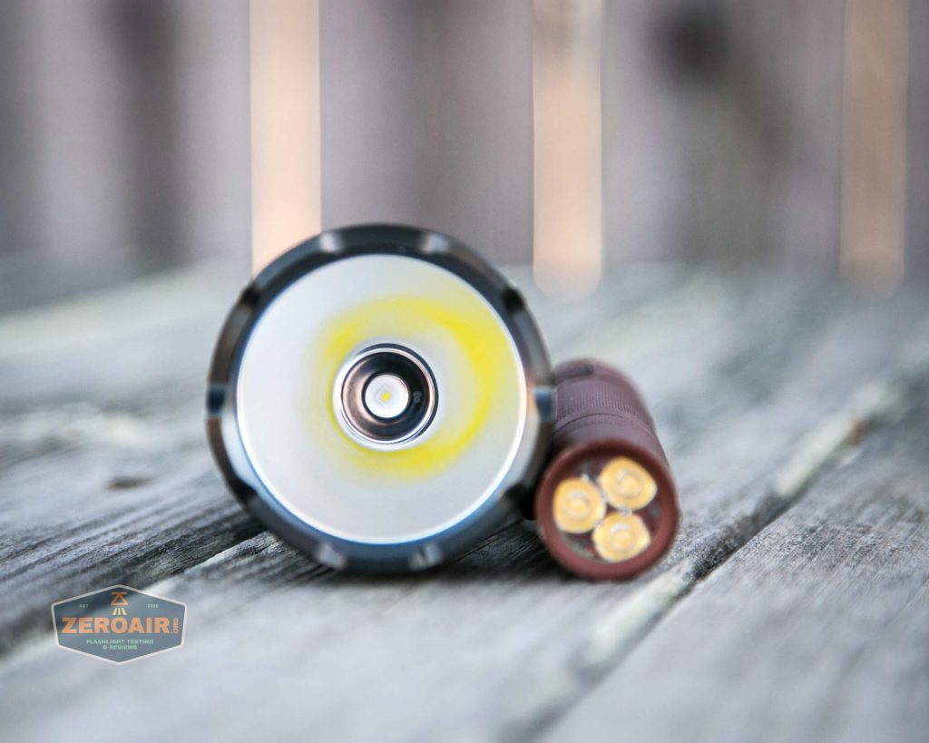 olight warrior x turbo desert tan flashlight beside convoy s2+