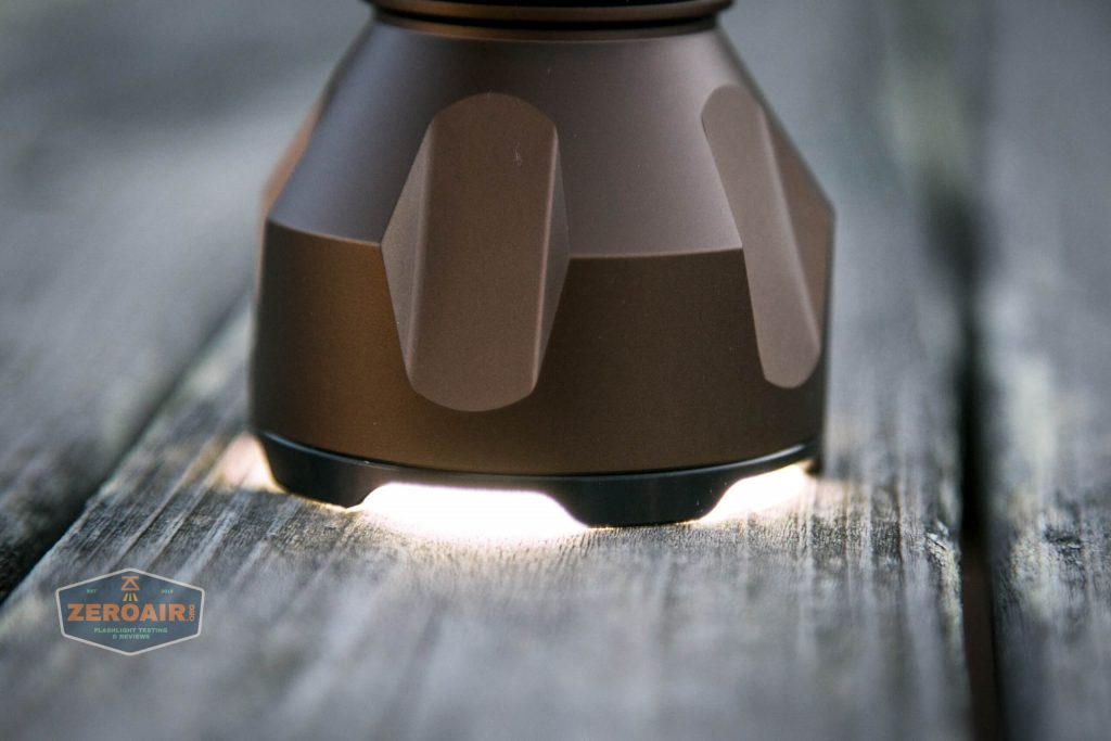 olight warrior x turbo desert tan flashlight headstanding on turbo