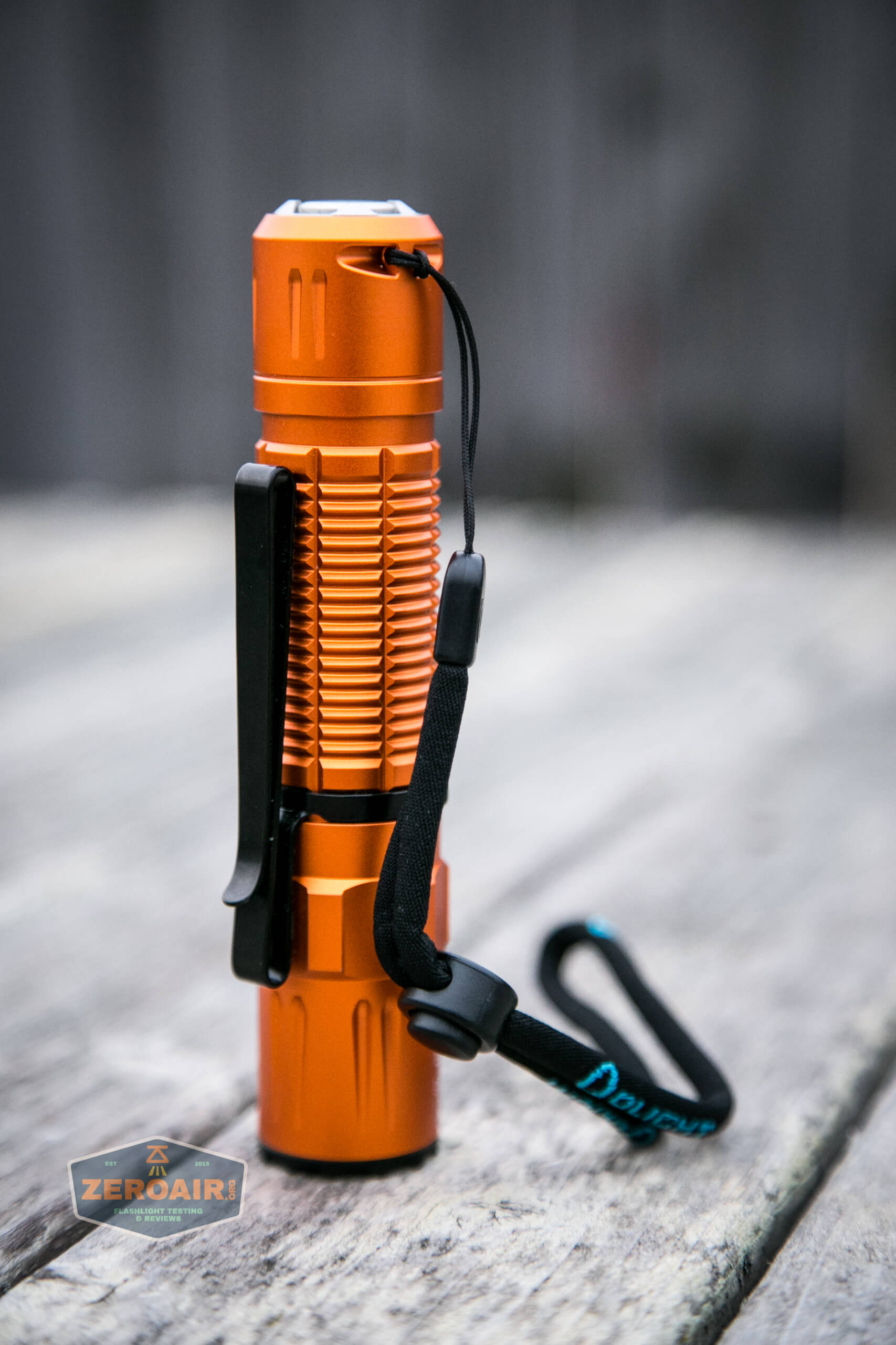 Olight M2R Pro Warrior Orange lanyard installed looking regal