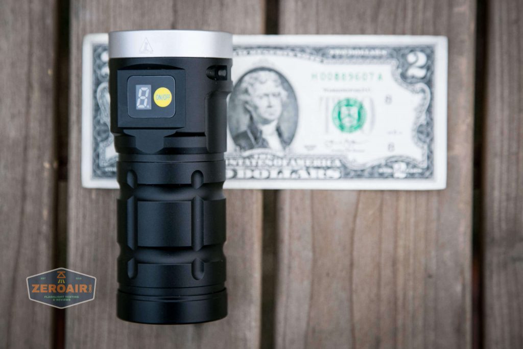 nitebeam x12uv flashlight on two dollar bill