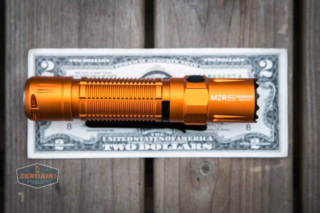 Olight M2R Pro Warrior Orange on two dollar bill