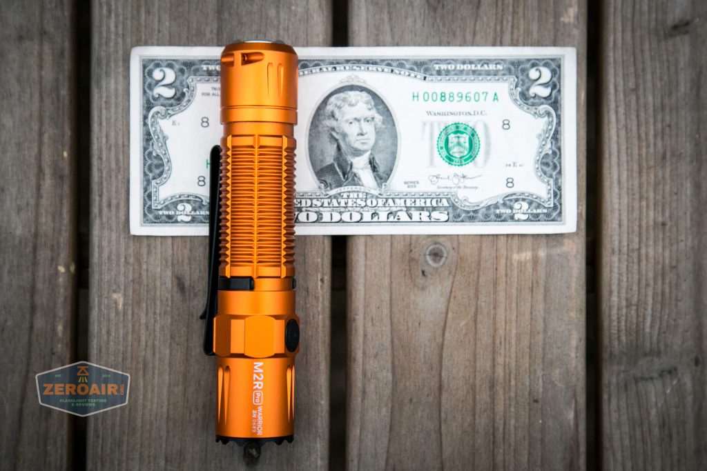 Olight M2R Pro Warrior Orange on two dollar bill