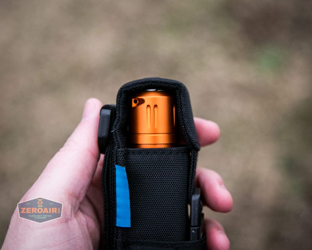 Olight M2R Pro Warrior Orange nylon pouch in hand bezel down