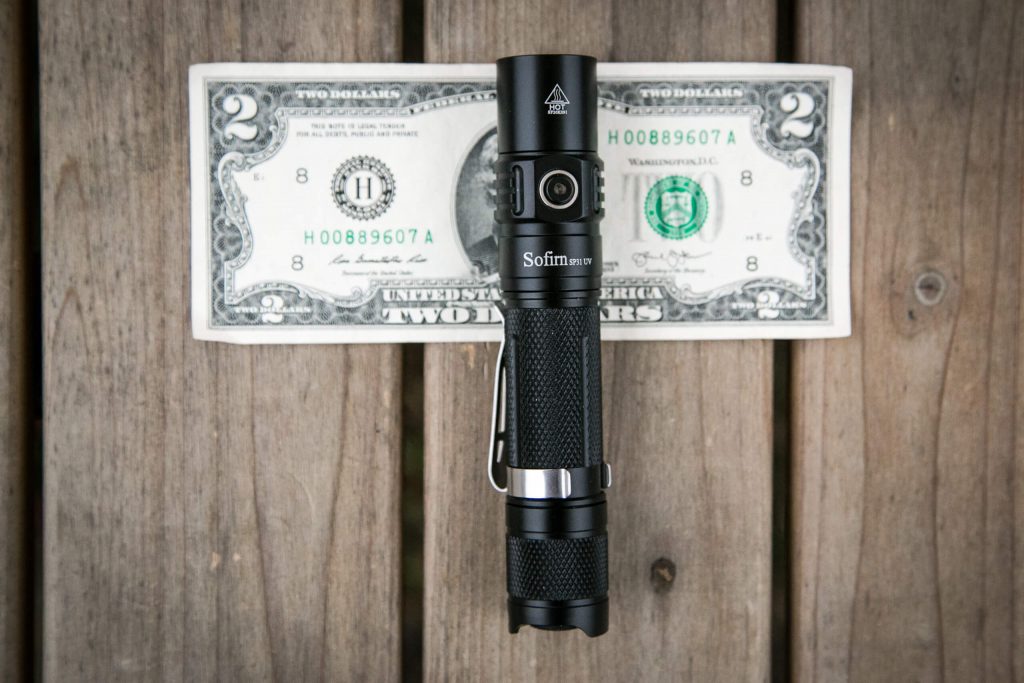 sofirn sp31uv ultraviolet 18650 flashlight on two dollar bill