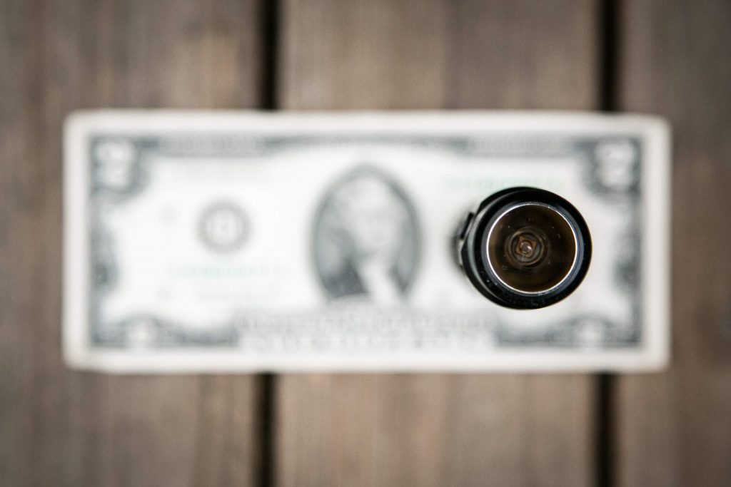 sofirn sp31uv ultraviolet 18650 flashlight on two dollar bill