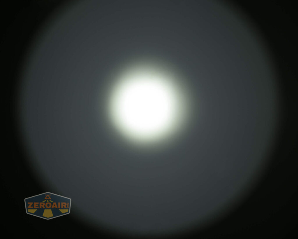A circular white light source creates a bright central spot with a halo effect against a dark background. The ZeroAir logo is visible in the lower left corner.