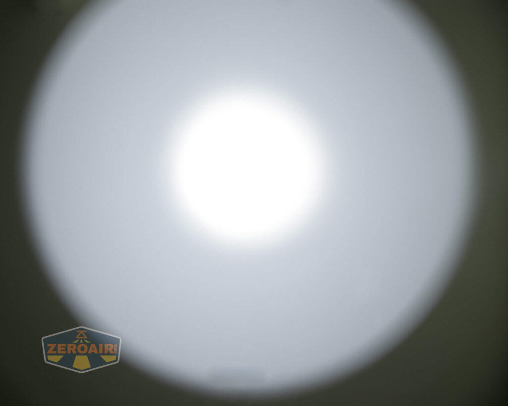 A bright white circular light is centered against a gray background. The ZeroAir logo is positioned in the lower left corner of the image.