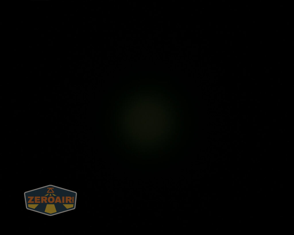 A mostly black image with a faint, dim circular light in the center and a small “ZeroAir” logo in the bottom left corner.