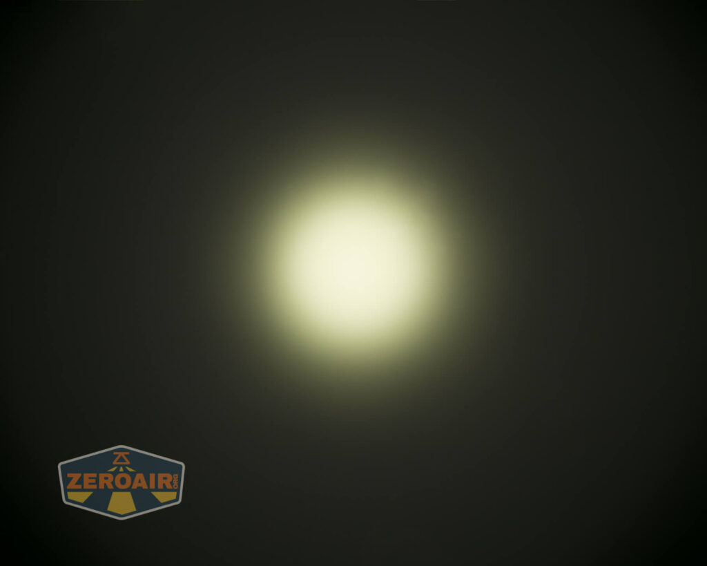 A circular white light with a yellowish tint appears in the center of a dark background. The ZeroAir logo is in the lower left corner.